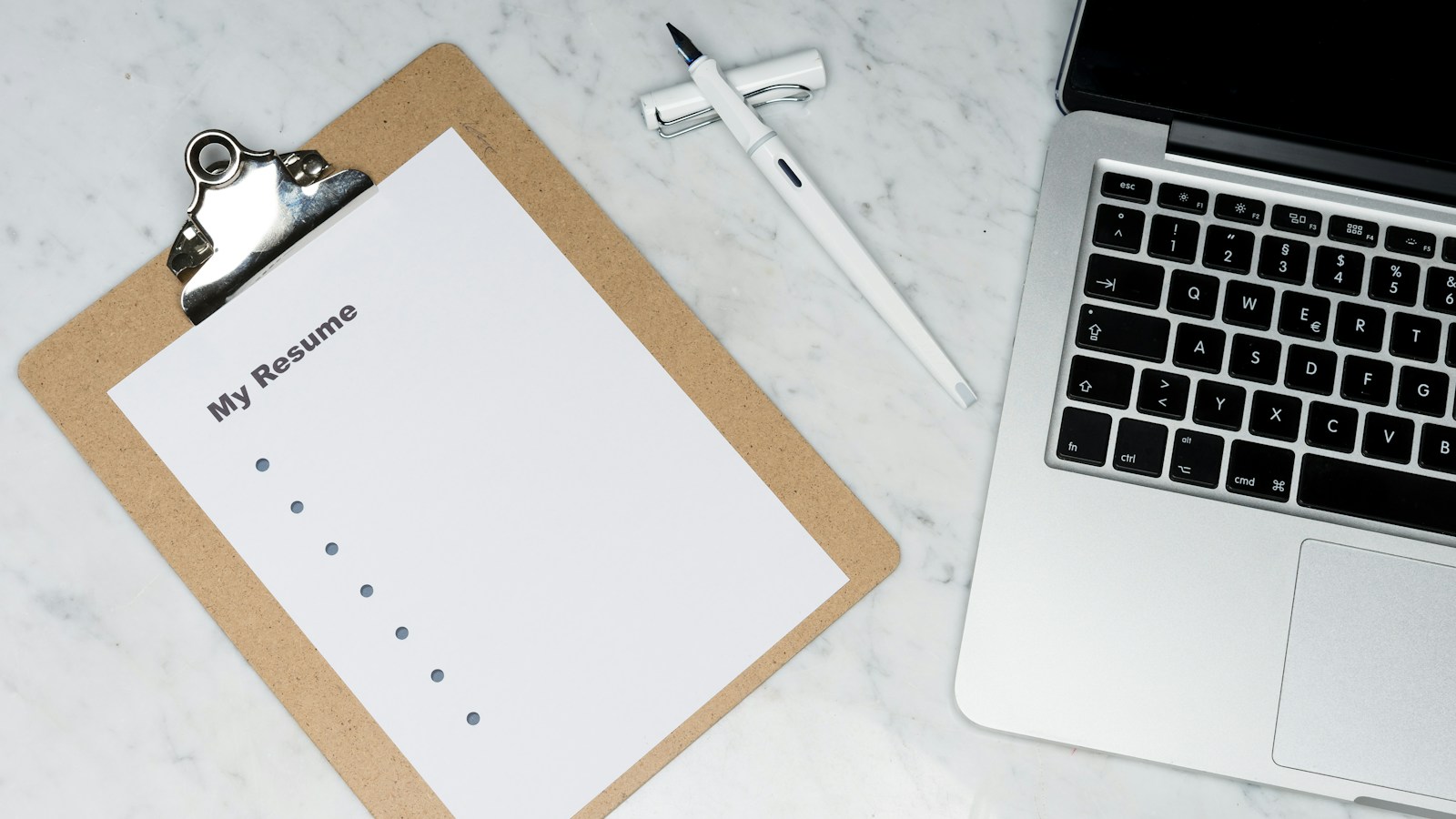 Thick, high-end printed B2B industrial machinery catalogue open on a conference table showing technical specification grids, product cutaways, schematics, and laminated tabs.