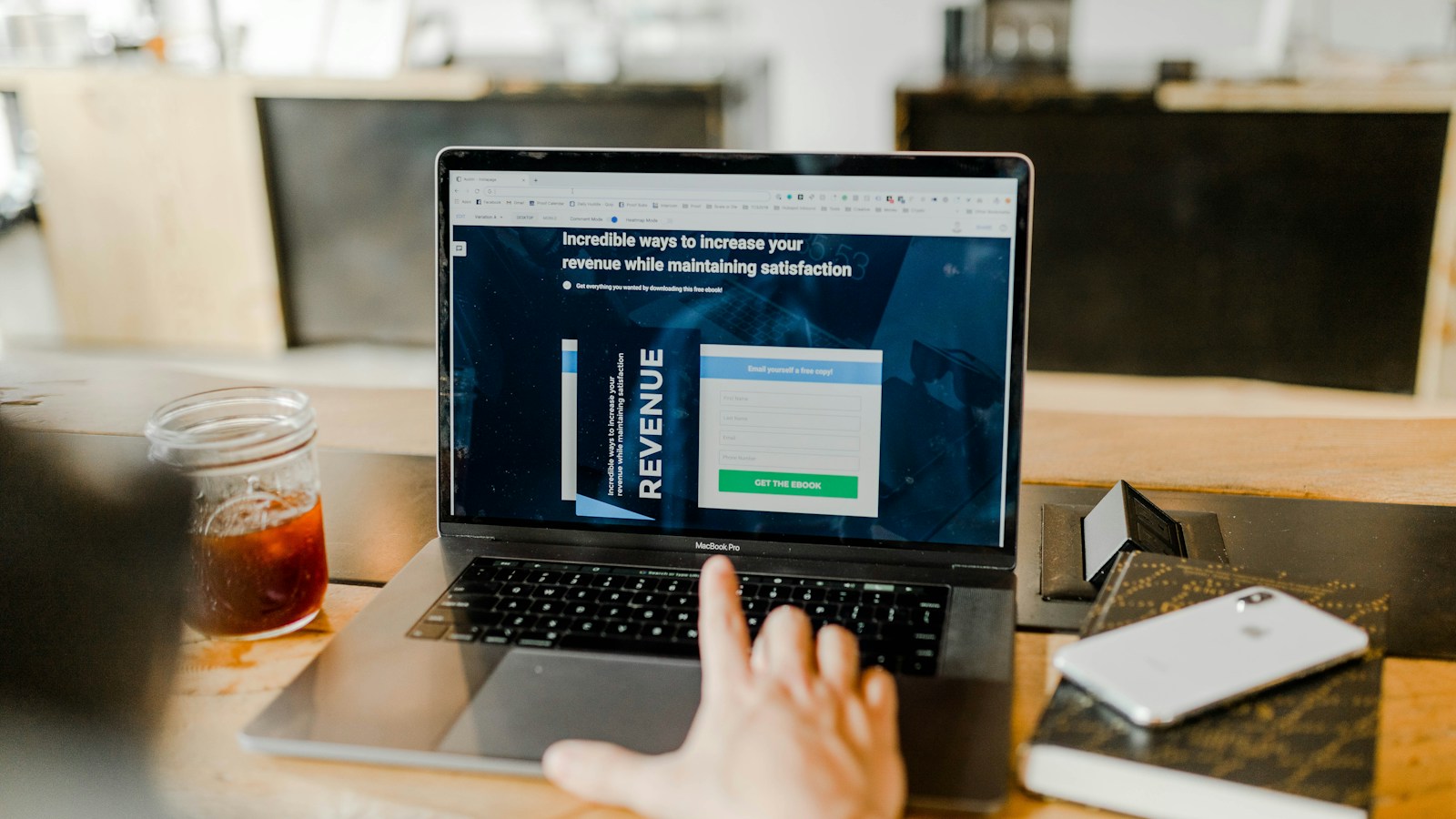 Local storefront business owner using a laptop to optimize Google Business Profile, local map pack rankings, customer review responses, and smartphone local navigation pins.