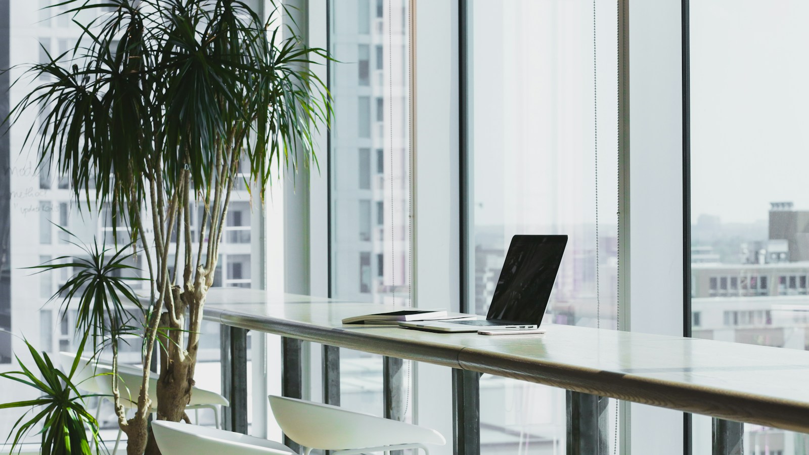 Corporate compliance meeting desk with an open laptop displaying an employee AI acceptable use policy document with customer privacy locks and acceptable use guidelines.
