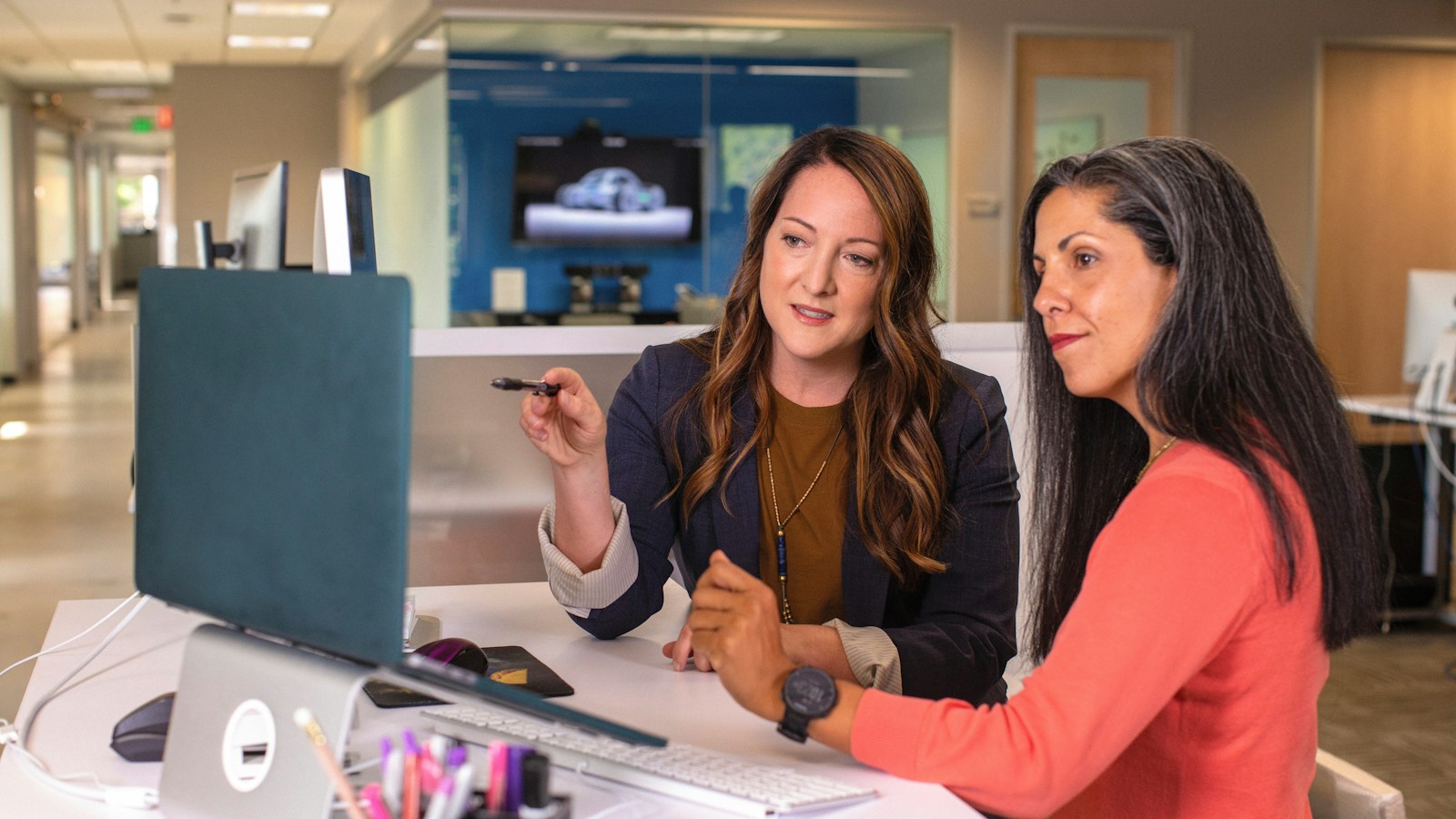 Modern customer service workstation with an executive wireless headset and microphone resting beside an oak desk and laptop displaying AI voice agent live transcription and sentiment.